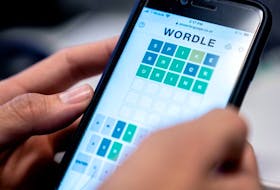 In three! A person plays the online word game Wordle on a mobile phone in 2022.