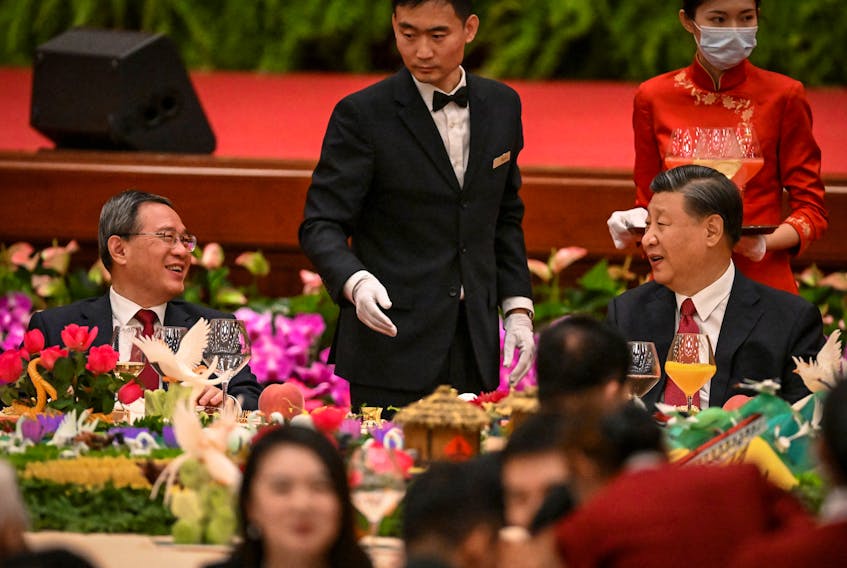 BEIJING (Reuters) - At a dinner reception before the 74th anniversary of the founding of modern China on Thursday, Chinese President Xi Jinping urged the nation to "work together in unity" in a speech