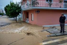 VOLOS, Greece (Reuters) - Torrential rain battered central Greece, flooding streets, homes and businesses in the city of Volos just three weeks after devastating Storm Daniel killed 16 people in the