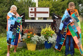 Jennie Stevens (left) and Mary Hatfield (right), seen standing in front of the memorial to Residential School survivors outside the Pictou Landing Band Office, say that part of the healing process is telling their stories and letting people know what happened. Angela Capobianco