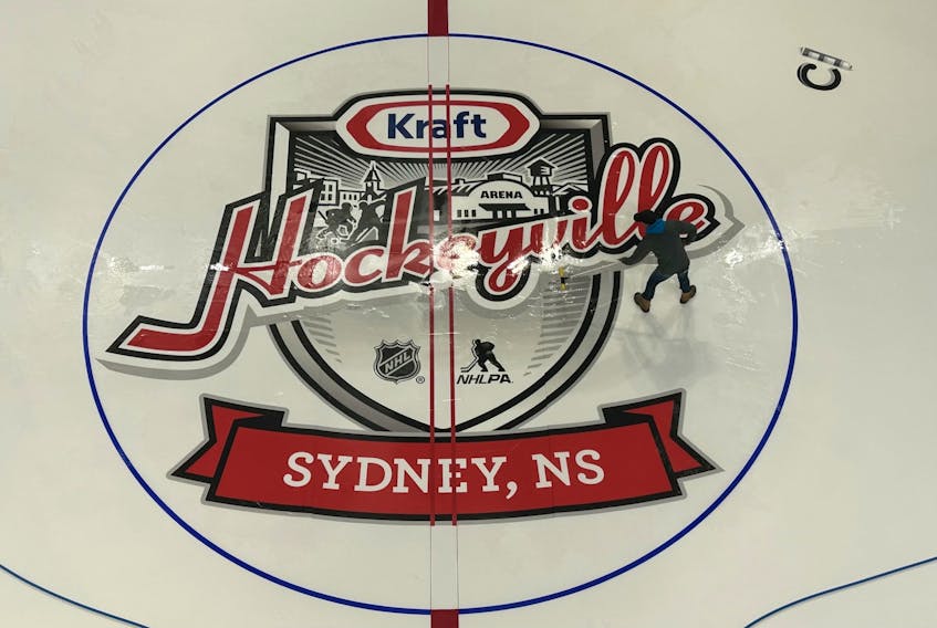 Centre 200 employee Brian Gillis pushes water across the newly installed centre ice logo for Kraft Hockeyville at the downtown Sydney venue on Wednesday evening. Centre 200 staff as well as members of the NHL's ice team installed the on-ice logos in preparation for the NHL pre-season game between the Florida Panthers and Ottawa Senators. The game will take place on Sunday at 5 p.m. with more than 4,000 people expected to attend. Kraft Hockeyville events begin today with a free community celebration from 3-7 p.m. at the Cape Breton University courtyard near the Canada Games Complex. The Cape Breton Post will have full coverage of Kraft Hockeyville in both print and online at saltwire.com/cape-breton/ throughout the weekend. JEREMY FRASER/CAPE BRETON POST