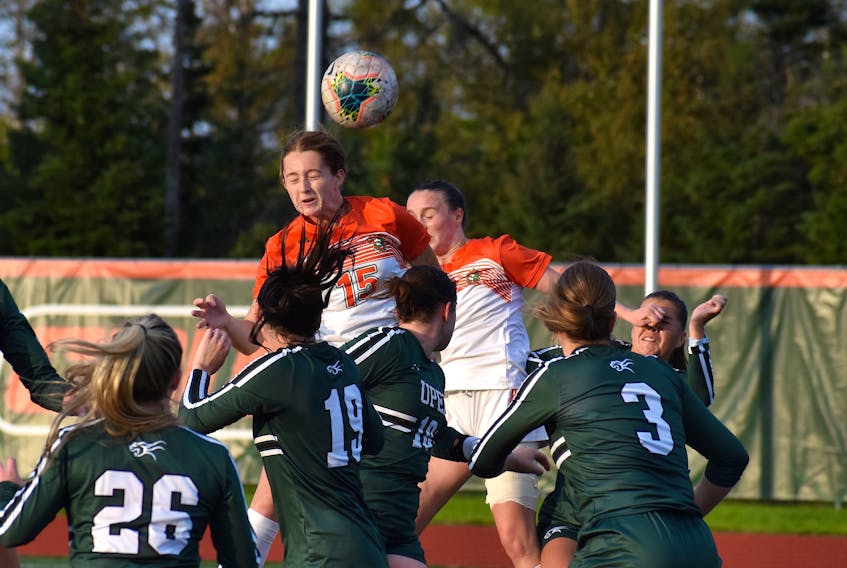 Charly Mitchell of the Cape Breton Capers, middle, heads the ball towards the net off a corner kick during Atlantic University Sport action against the Prince Edward Island Panthers at Ness Timmons Field in Sydney on Friday. Cape Breton won the game 5-2. JEREMY FRASER/CAPE BRETON POST.