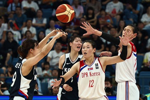By Ian Ransom HANGZHOU, China (Reuters) - Having played in a unified team at the Asian Games in Jakarta five years ago, North and South Korea's women basketballers battled each other in Hangzhou on