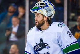 Canucks goalie Spencer Martin during a break in their National Hockey League game in Calgary against the Flames on Dec. 14, 2022.