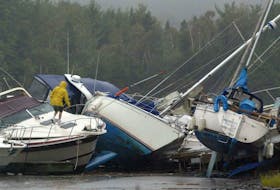 FOR JUAN STORIES:
A boater inspects thrown sailboats at the Dartmouth Yacht Club, following Hurricaine Juan's ravages, Monday.

Photo by Tim Krochak