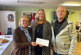 President of the New Horizon's Senior's Club Hilda Smith (left) and Terry Donovan Chair of the Board of Directors, and Chair of Maintenance Committee (right) receiving funding from Karla MacFarlane and the Department of Communities Culture Tourism & Heritage to continue renovations to the club - Sarah Jordan