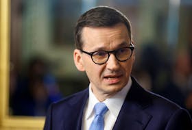 WARSAW (Reuters) - Poland will uphold its veto on a European Union migration pact, its prime minister said on Friday, as the bloc searches for agreement on a system for the sharing out asylum seekers