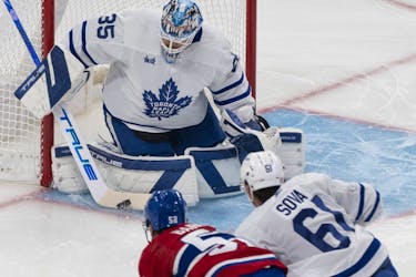Toronto Maple Leafs goaltender Ilya Samsonov (35) makes a save against Montreal Canadiens' Justin Barron (52) as Leafs' Spencer Sova (61) skates in during first period NHL preseason hockey action in Montreal on Friday, Sept. 29, 2023. 