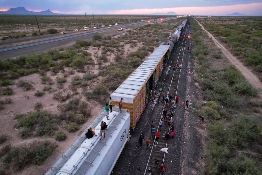 VILLA AHUMADA/PIEDRAS NEGRAS (Reuters) - Migrants were stranded in Mexico on Friday miles from the U.S. border after the freight train they were traveling on top of abruptly stopped, amid the ongoing