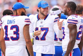Josh Allen (centre) of the Buffalo Bills laughs with Gabe Davis and Latavius Murray.