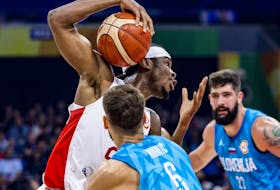 Shai Gilgeous-Alexander of Canada drives to the basket against Aleksej Nikolic of Slovenia during the FIBA Basketball World Cup.