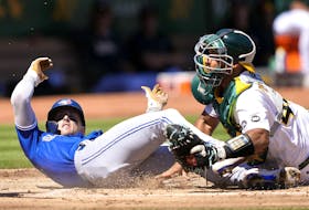 Blue Jays' Cavan Biggio scores sliding past catcher Carlos Perez of the Athletics in the top of the second inning at RingCentral Coliseum on Wednesday, Sept. 6, 2023 in Oakland. 