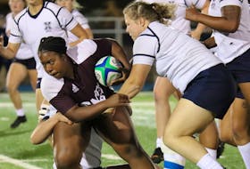 Brianna Willis, then of the Saint Mary's Huskies, powers through the tackling of the St. Francis Xavier X-Women during Atlantic university rugby action in 2021. After redshirting last season, Willis will suit up for St. F.X. in its season opener Saturday against SMU. - SAINT MARY'S ATHLETICS