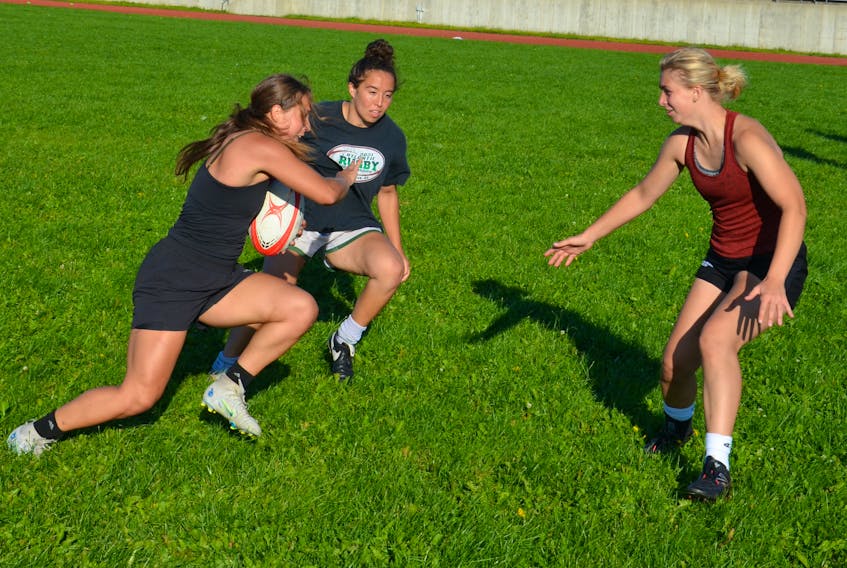 The action is intense as Lauren Misener carries the ball during a UPEI women’s rugby team practice at MacAdam Field on the UPEI campus in Charlottetown on Sept. 5. Ria Johnston, middle, and Brooklyn Harrison are also taking part in the drill. UPEI opens the 2023 Atlantic University Sport Women’s Rugby Conference regular season against Acadia at MacAdam Field on Sept. 9 at 2 p.m. Jason Simmonds • The Guardian