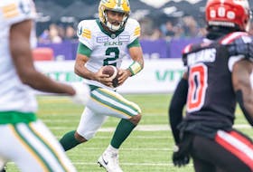 Edmonton Elks quarterback Tre Ford runs the ball against the Calgary Stampeders during the Labour Day Classic at McMahon Stadium on Monday, Sept. 4, 2023.