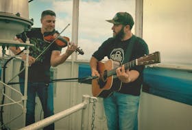 Daniel LeBlanc (left) on the fiddle and Charles Robicheau on the guitar at the top of the Cape Forchu Lighthouse as part of The Lantern Room sessions – a partnership between the District of Yarmouth and the Yarmouth & Acadian Shores Tourism Association (YASTA) to showcase local artists and the lighthouse. CONTRIBUTED