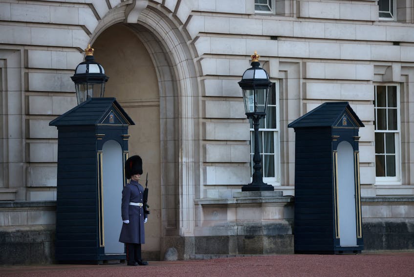 A guard wearing a bearskin cap stands outside Buckingham Palace in London, Britain January 10, 2024.