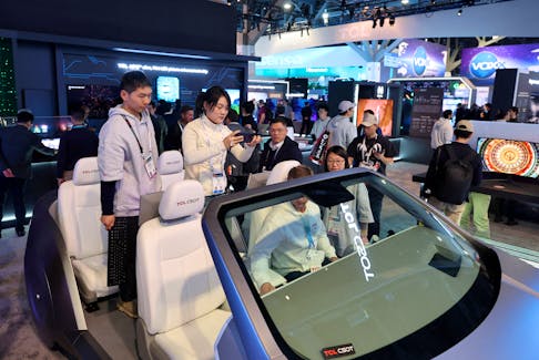 Attendees look at China Star Optoelectronics Technology (CSOT) automotive display panels in the TCL booth at CES 2024, an annual consumer electronics trade show, in Las Vegas, Nevada, U.S. January 9, 2024.