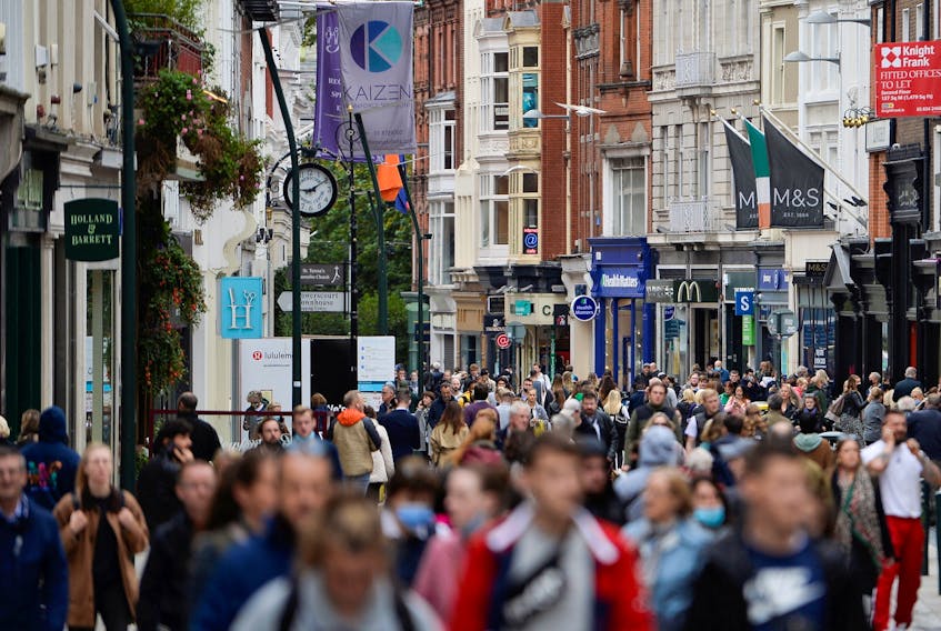 People walk in a busy retail street in Dublin, Ireland, October 12, 2021.