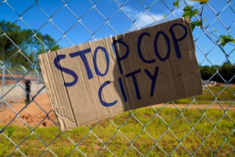 A placard is seen on a fence as people protest at the site of the Atlanta police training center, derisively called "Cop City", days after more than five dozen activists were charged with an illegal conspiracy to stop construction of the facility, near Atlanta, Georgia, U.S., September 7, 2023. 