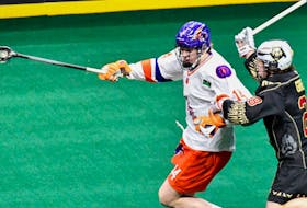 Halifax Thunderbirds rookie defender Calen Mander, in his National Lacrosse League debut, fends off Nathan Grenon of the Albany FireWolves on Saturday night in Albany, N.Y. - National Lacrosse League