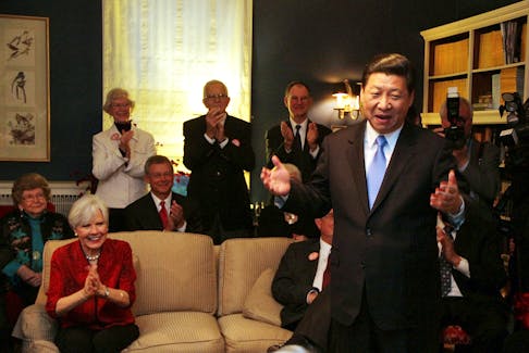 China's Vice President Xi Jinping speaks at the home of Roger and Sarah Lande (2nd L) in Muscatine, Iowa February 15, 2012. Xi joked about receiving a gift of popcorn during his first visit to Muscatine in 1985. 