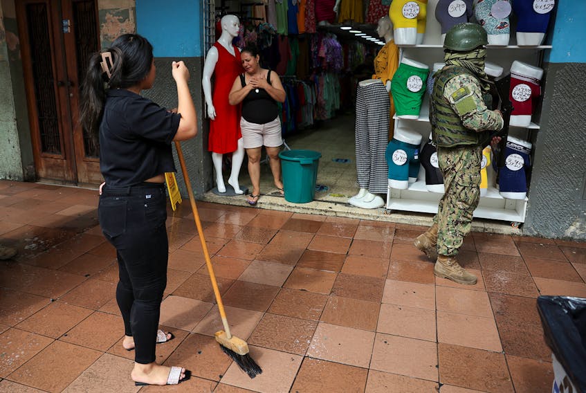 An armed soldier patrols a commercial area, in the aftermath of a wave a violence that saw the storming of a TV station on-air and explosions around the nation, in Quito, Ecuador, January 11, 2024.