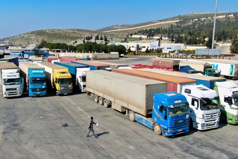 Trucks carrying aid from UN  World Food Programme (WFP), following a deadly earthquake, are parked at Bab al-Hawa crossing, Syria February 20, 2023. 
