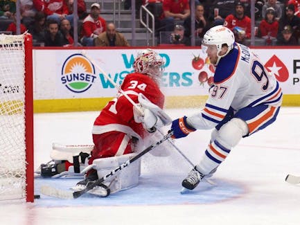 Connor McDavid #97 of the Edmonton Oilers scores a third period goal past Alex Lyon #34 of the Detroit Red Wings at Little Caesars Arena on January 11, 2024 in Detroit, Michigan. Edmonton Oilers won the game 3-2 in overtime.
