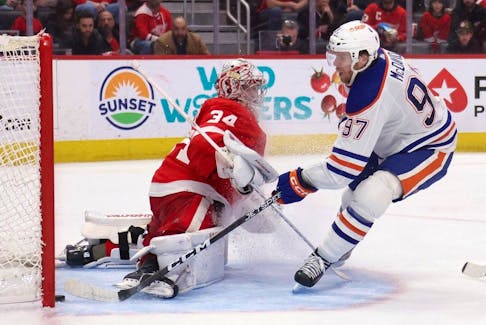 Connor McDavid #97 of the Edmonton Oilers scores a third period goal past Alex Lyon #34 of the Detroit Red Wings at Little Caesars Arena on January 11, 2024 in Detroit, Michigan. Edmonton Oilers won the game 3-2 in overtime.