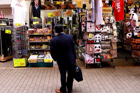 A man looks at a shop at the Ameyoko shopping district in Tokyo, Japan, May 20, 2022.