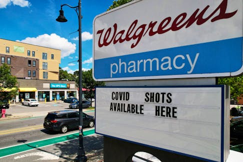 A sign advertises COVID-19 (coronavirus) vaccine shots at a Walgreens Pharmacy in Somerville, Massachusetts, U.S., August 14, 2023.    