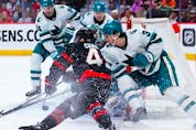  Sharks defenceman Henry Thrun (3) tries to stop Senators centre Rourke Chartier (49) from wrapping the puck around the net during the second period of Saturday’s game at the Canadian Tire Centre.