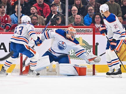 Edmonton Oilers goaltender Stuart Skinner (74) reaches for the puck against the Montreal Canadiens at Bell Centre on Saturday, Jan. 13, 2024, in Montreal.