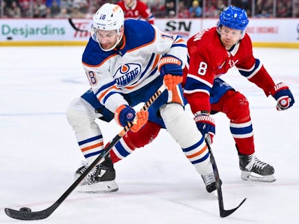 Zach Hyman (18) of the Edmonton Oilers carries the puck against Mike Matheson (8) of the Montreal Canadiens at Bell Centre on Saturday, Jan. 13, 2024, in Montreal.