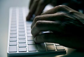 A person types on a computer keyboard in this stock photo.