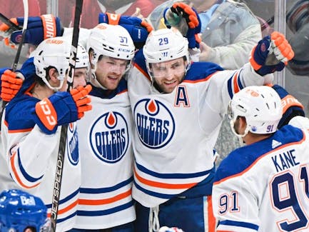 Edmonton Oilers' Leon Draisaitl (29) celebrates with teammates after scoring against the Montreal Canadiens during third period NHL hockey action in Montreal on Saturday, Jan. 13, 2024. 