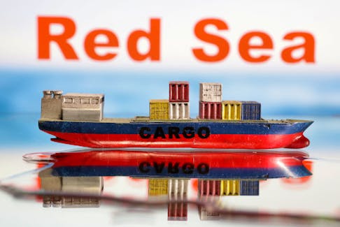 A cargo ship boat model is seen in front of "Red Sea" words in this illustration taken January 9, 2024.