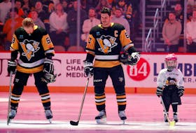 Little Penguins youth hockey participant Samantha Britt (right) stands for the national anthem alongside Pittsburgh Penguins centre Sidney Crosby (87) and left-winger Jake Guentzel (59) before a Jan. 6 game against the Buffalo Sabres at PPG Paints Arena in Pittsburgh. - Charles LeClaire-USA TODAY Sports