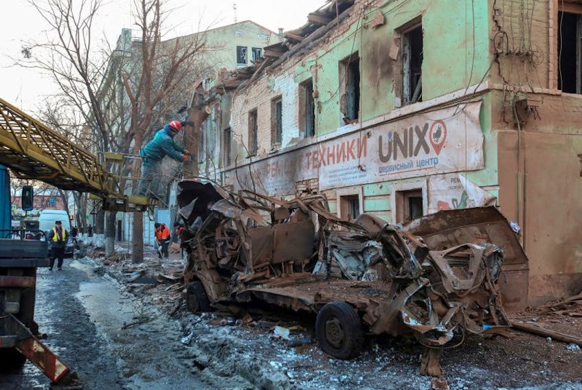 Municipal workers remove debris at a site of a Russian missile strike, amid Russia's attack on Ukraine, in central Kharkiv, Ukraine January 17, 2024.