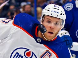 Connor McDavid (97) of the Edmonton Oilers keeps his eyes on the puck against the Tampa Bay Lightning at Amalie Arena on Nov. 18, 2023, in Tampa, Fla.