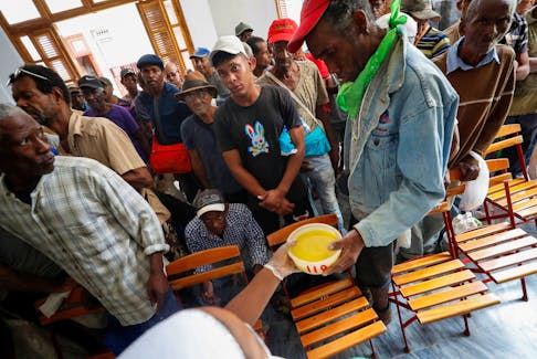 People receive food at a soup kitchen run by religious group Quisicuaba that is serving a growing number of Cubans struggling to make ends meet amid economic crisis, in Havana, Cuba January 15, 2024.