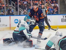 Connor McDavid (97) of the Edmonton Oilers can't handle the rebound off the pad of Seattle Kraken goalie Joey Daccord (35) at Rogers Place in Edmonton on Thursday, Jan.18, 2024.