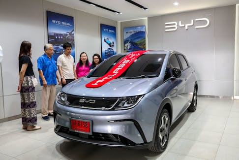 Apisak Phichitkarnka, 30, and his family members inspect a BYD Dolphin EV car at a show room in Bangkok, Thailand, January 17, 2024.