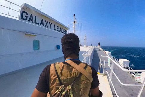 A Houthi fighter stands on the Galaxy Leader cargo ship in the Red Sea in this photo released November 20, 2023. Houthi Military Media/Handout via