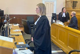 Prosecutor Nicole Hurley awaits the entrance of Justice Valerie Marshall for Matthew Power's trial in Newfoundland and Labrador Supreme Court in St. John's Thursday, Jan. 18. Power speaks with his lawyer, Rosellen Sullivan, in the background
