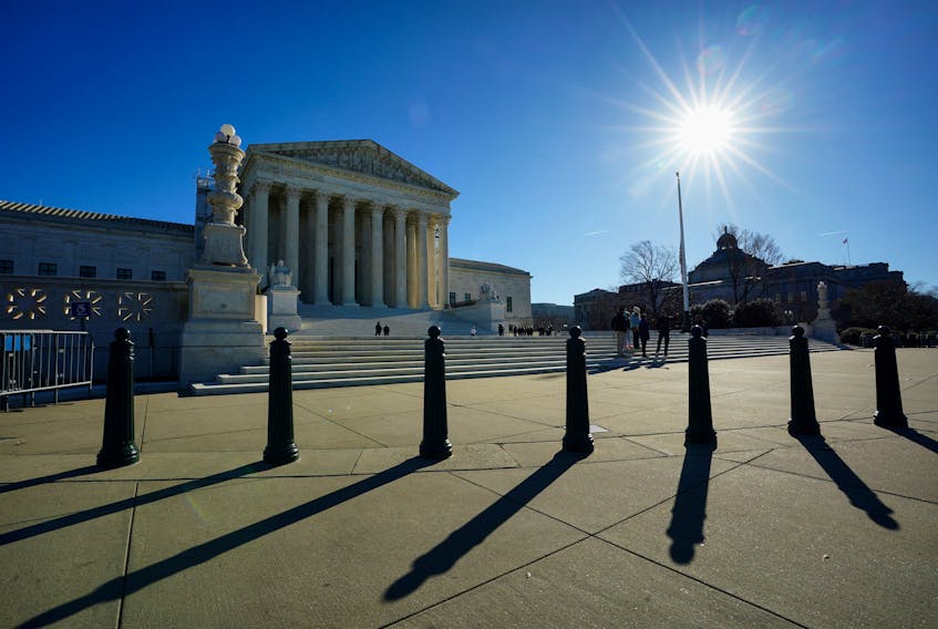 The sun casts shadows as it rises over the U.S. Supreme Court in Washington, U.S., December 20, 2023.