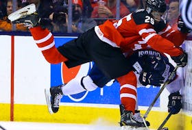 Darnell Nurse of Team Canada runs into Robert Lantosi of Team Slovakia in the semi-finals of 2015 world junior championship at the Air Canada Centre in Toronto on Jan. 4, 2015.