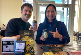 Hai Nguyen, right, of The Shed Coffee in Charlottetown, shows her canned coffee products to Victor-Antoine Gauthier of Axelr last November.