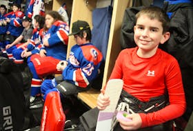 Ryan Primmer tapes up his hockey stick in purple tape before the Cape Breton County "B" Islanders U13 team's first MacDonald Gallagher tournament game against the Halifax Hawks Friday afternoon. NICOLE SULLIVAN/CAPE BRETON POST